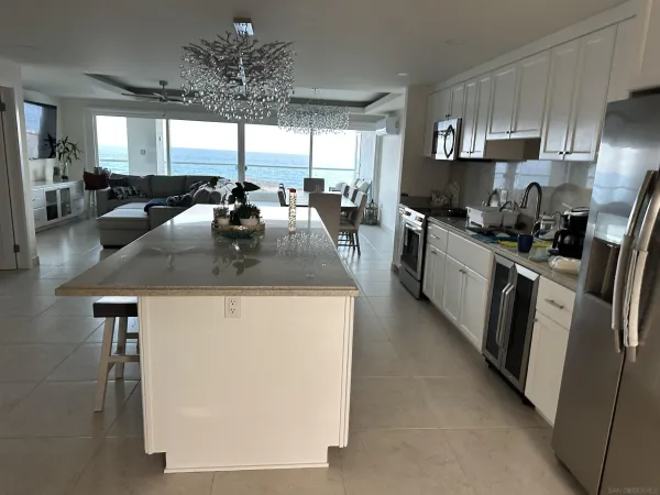 a kitchen with stainless steel appliances granite countertop a sink a stove and a refrigerator