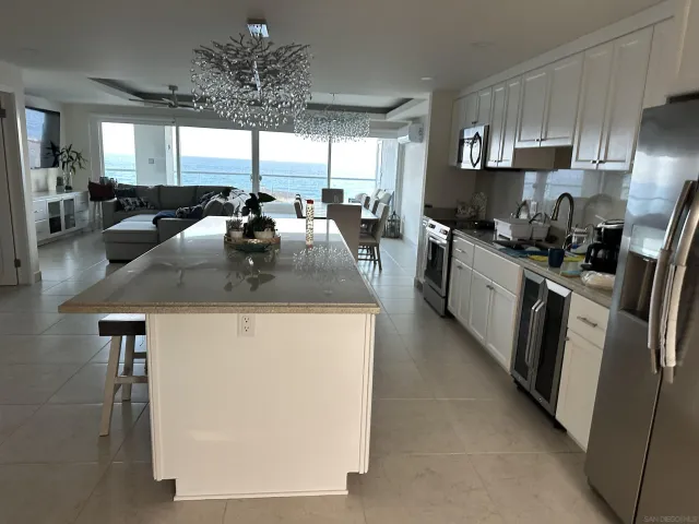 a kitchen with stainless steel appliances granite countertop a sink a stove and a refrigerator