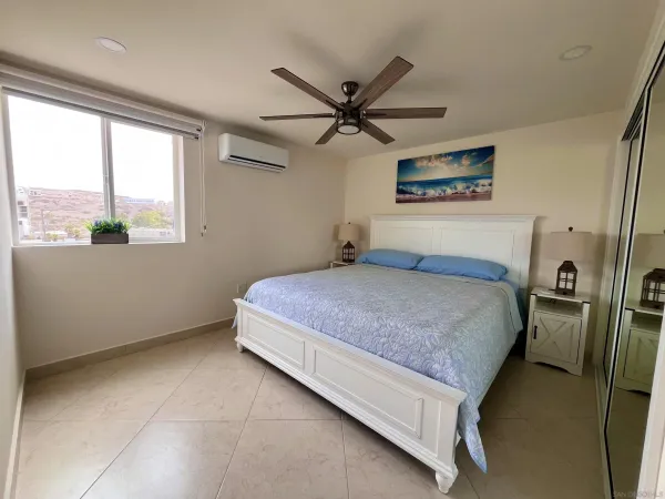 a bedroom with a bed and window
