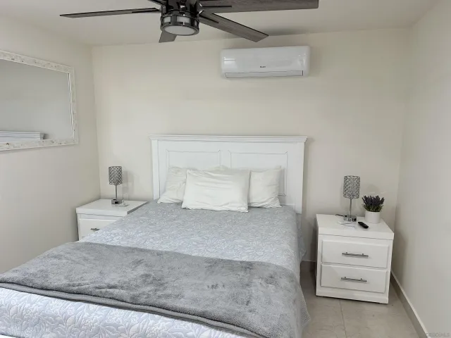 a bedroom with a bed and dresser