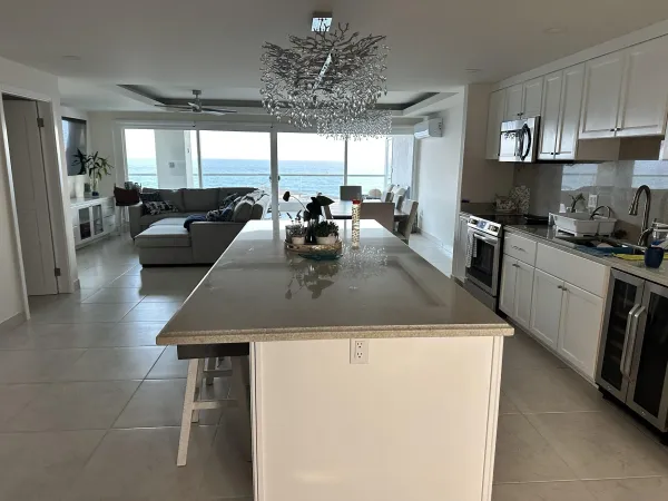 a kitchen with stainless steel appliances granite countertop a sink a stove and a refrigerator