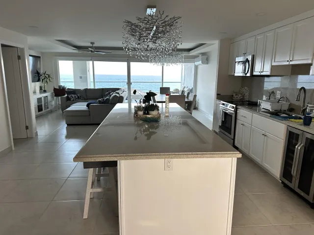 a kitchen with stainless steel appliances granite countertop a sink a stove and a refrigerator