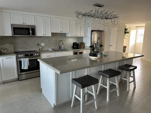 a kitchen with a dining table chairs and a refrigerator
