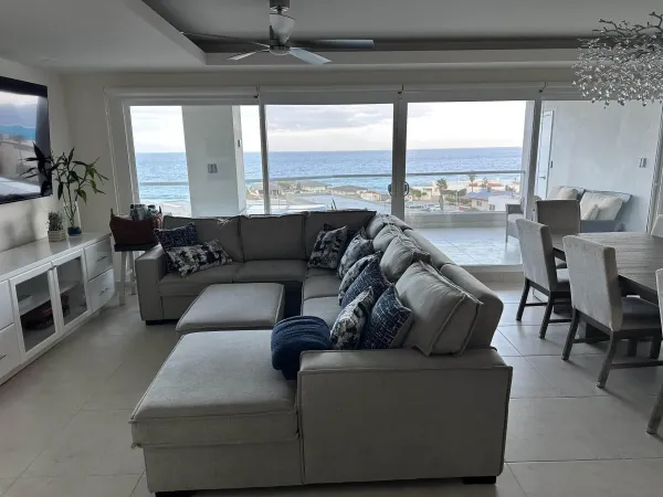 a living room with furniture and large windows