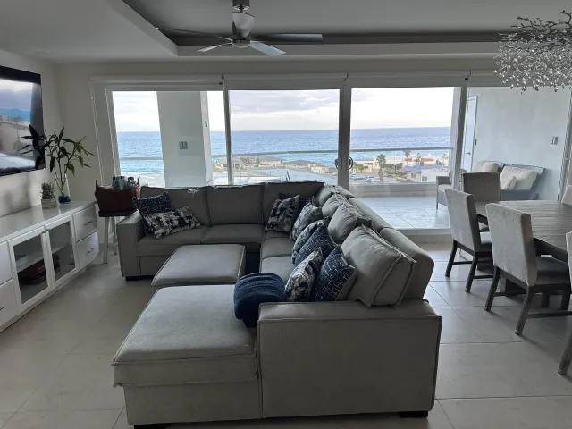 a living room with furniture and large windows