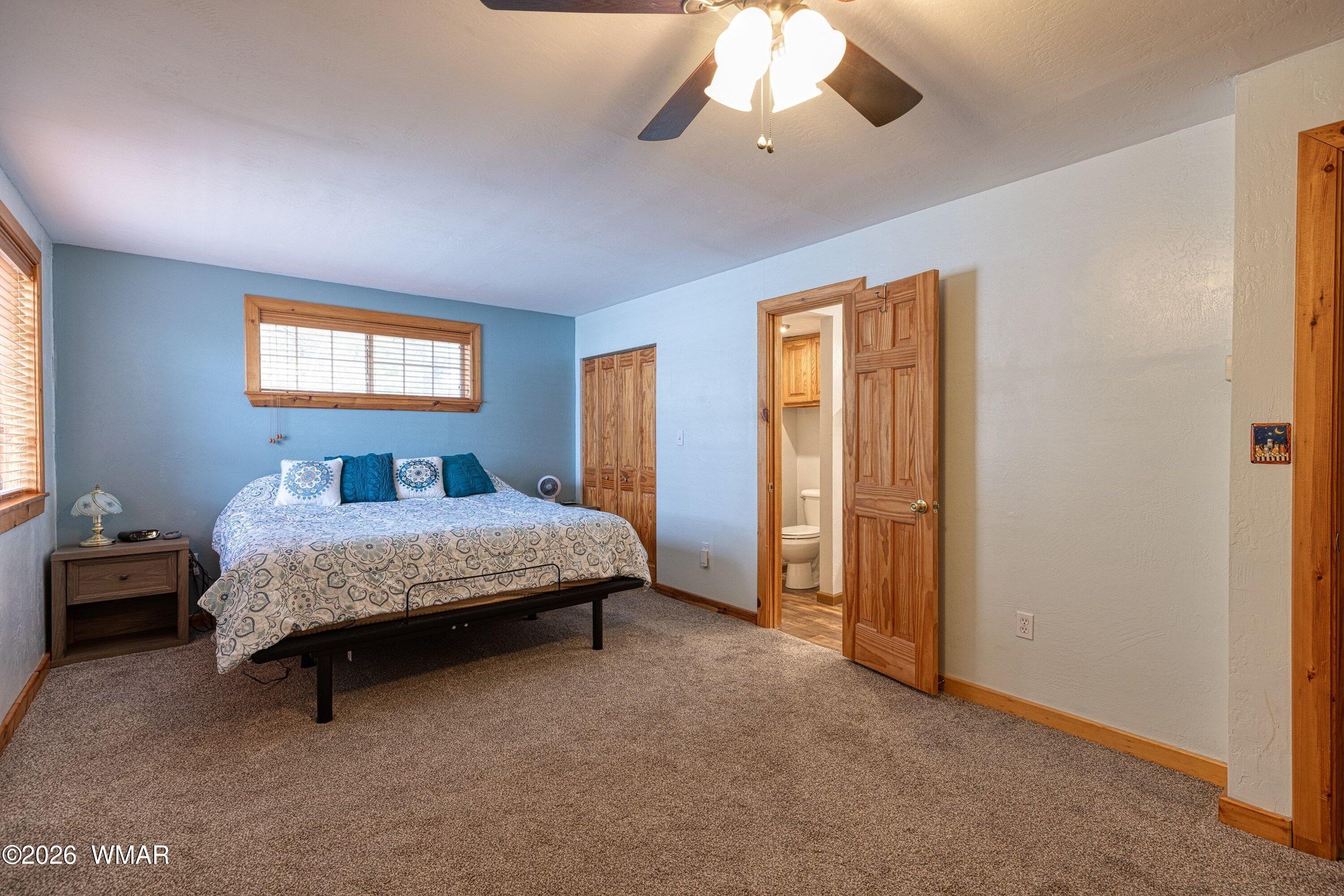 1306 West Pima Lane Lakeside, AZ 85929 - Photo 13 of 31 a bedroom with a bed and a chandelier