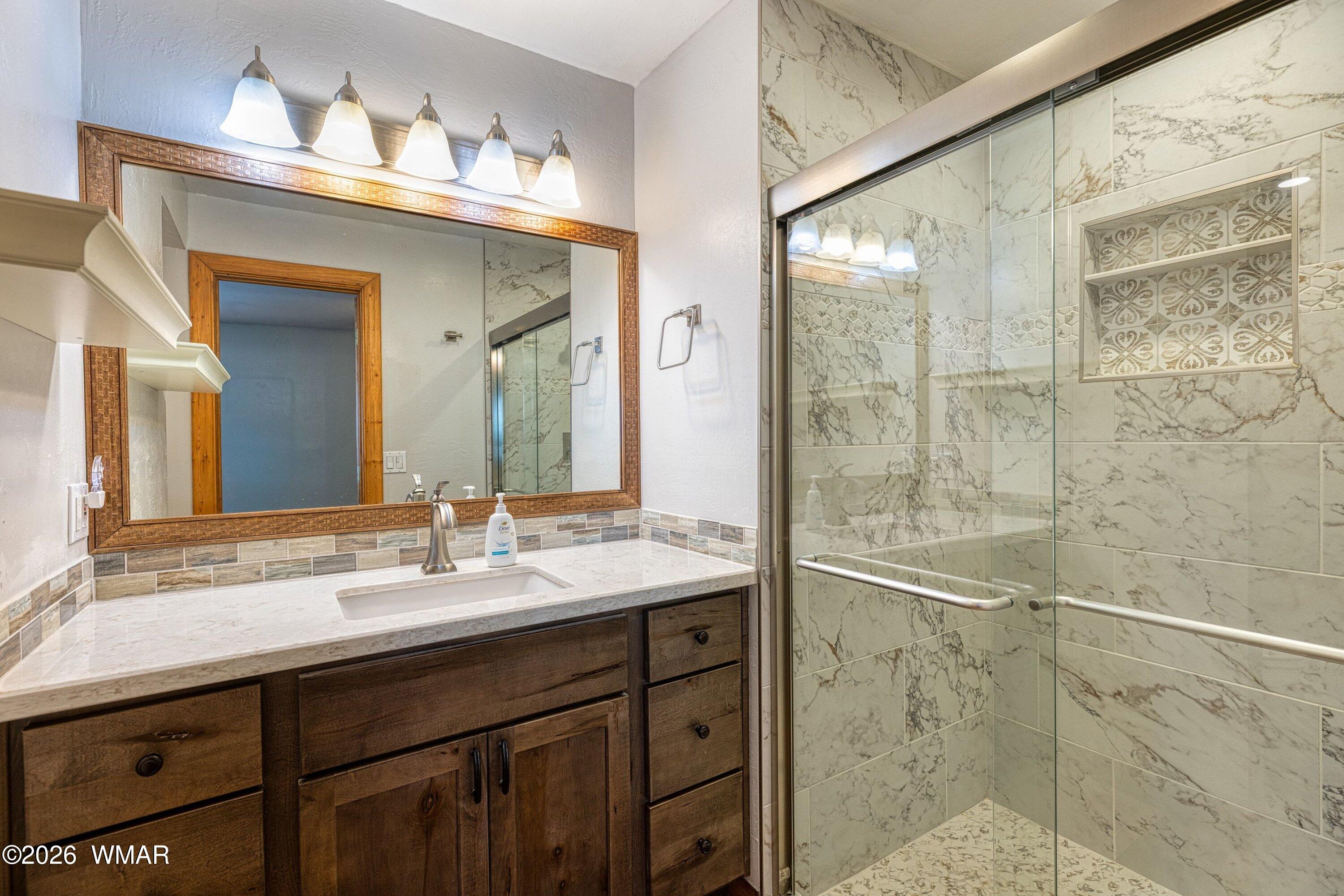 1306 West Pima Lane Lakeside, AZ 85929 - Photo 14 of 31 a bathroom with a granite countertop sink mirror and double