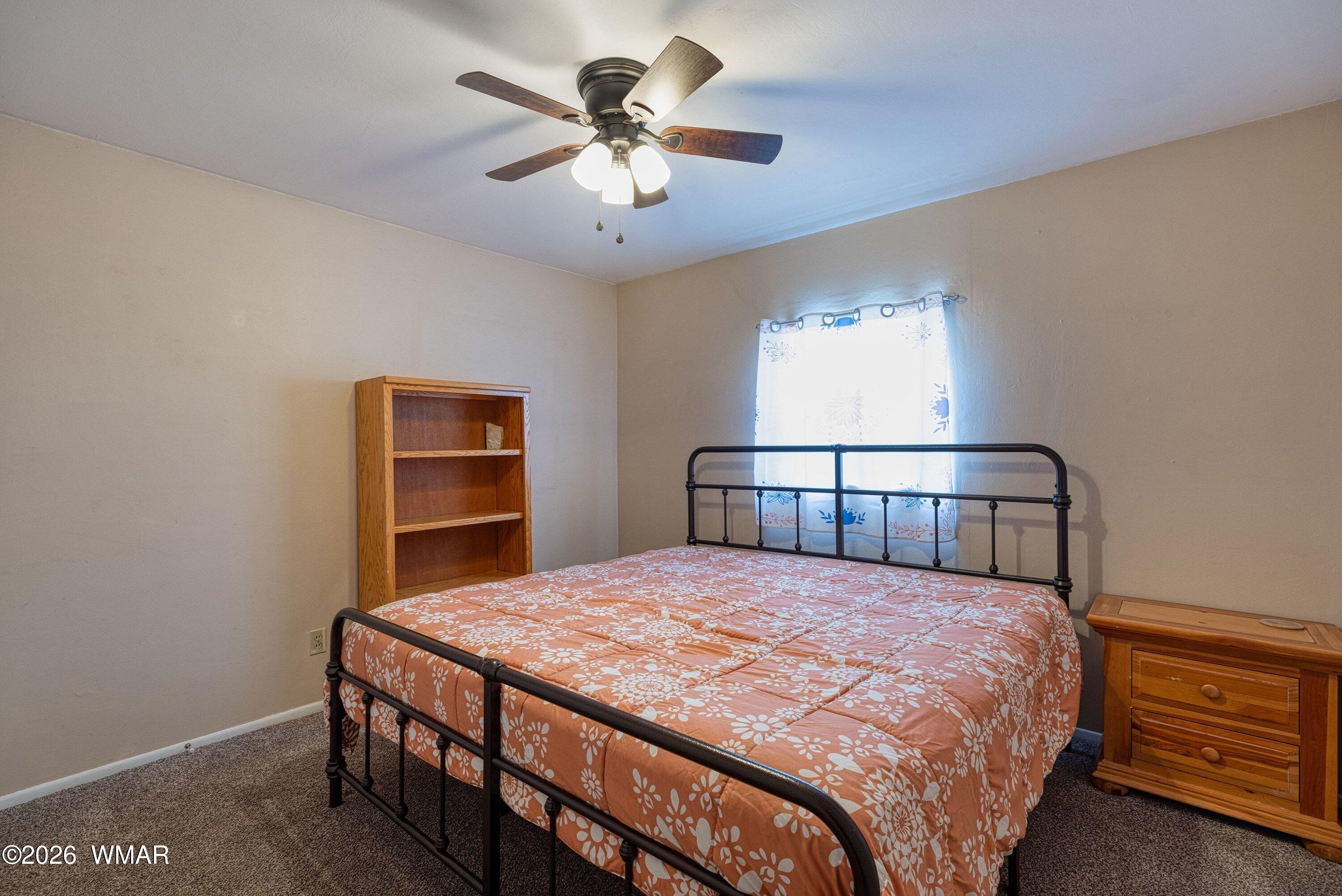 1306 West Pima Lane Lakeside, AZ 85929 - Photo 16 of 31 a bedroom with a bed and a chandelier