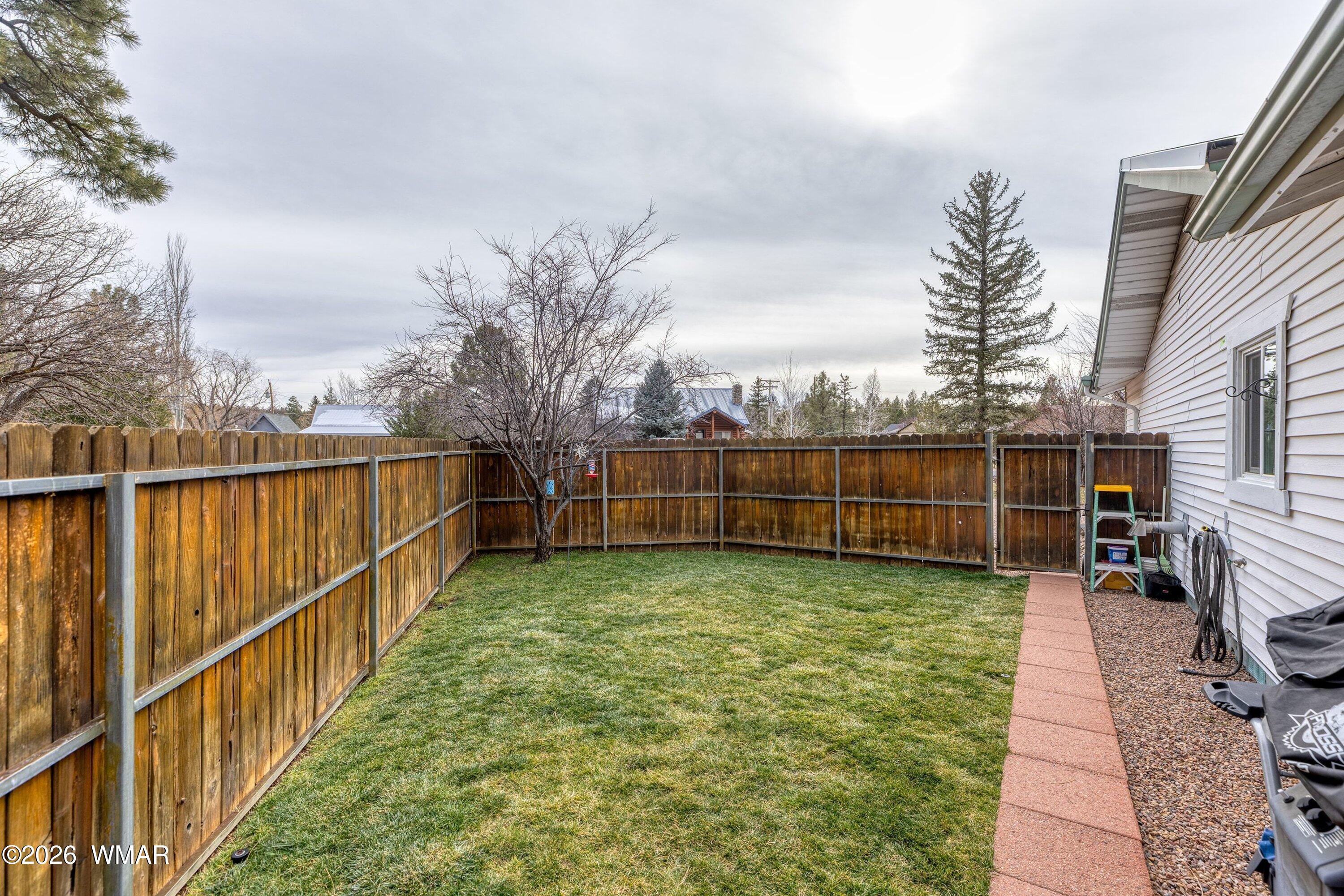 1306 West Pima Lane Lakeside, AZ 85929 - Photo 22 of 31 a view of a backyard with wooden fence