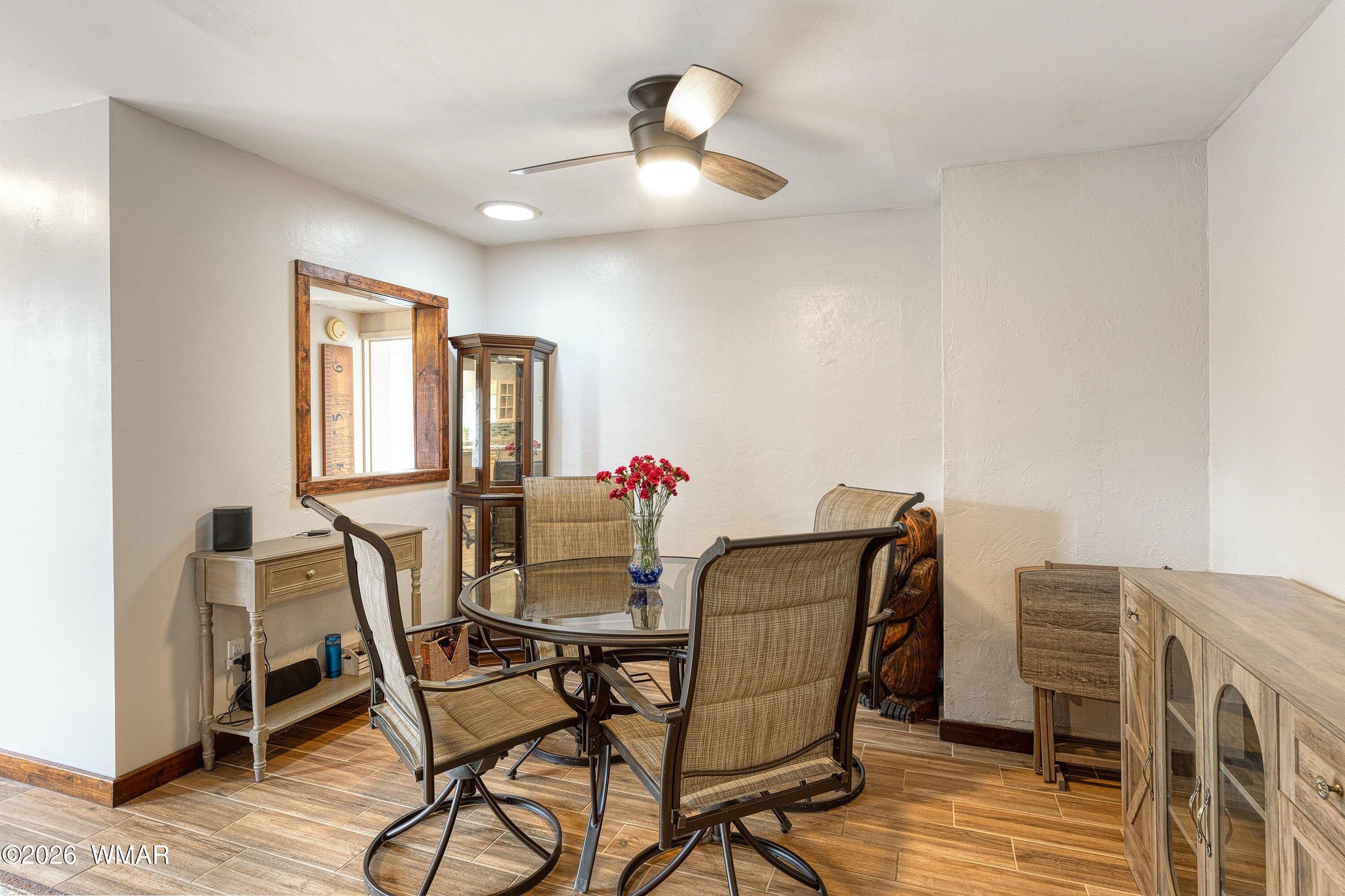 1306 West Pima Lane Lakeside, AZ 85929 - Photo 10 of 31 a view of a dining room with furniture and a chandelier