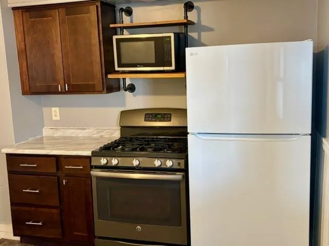 a kitchen with a refrigerator stove and microwave