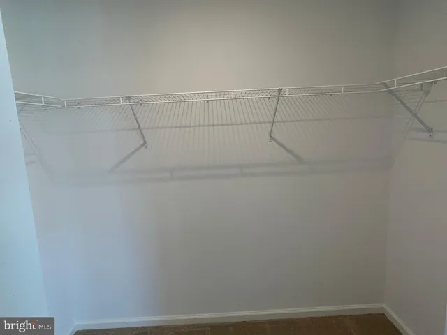 a bathroom with a granite countertop sink a mirror and a shower