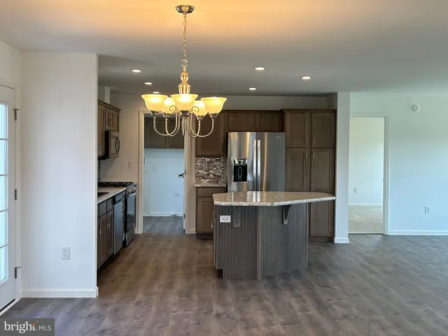 a view of a room with wooden floor and chandelier
