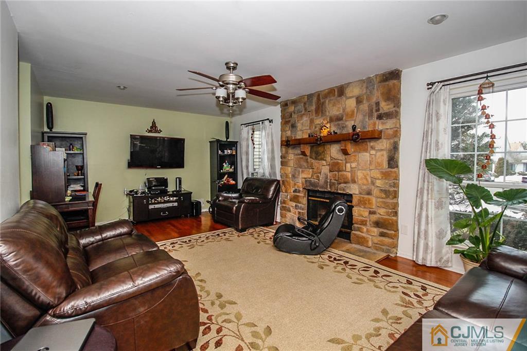 601 Maplecrest Road, Unit 601 Edison, NJ 08820 - Photo 13 of 25 a living room with furniture a fireplace and a flat screen tv