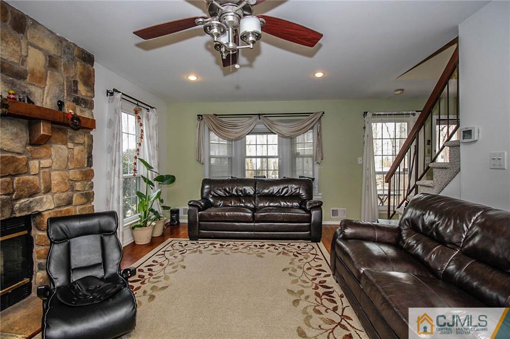 601 Maplecrest Road, Unit 601 Edison, NJ 08820 - Photo 14 of 25 a living room with furniture and a chandelier