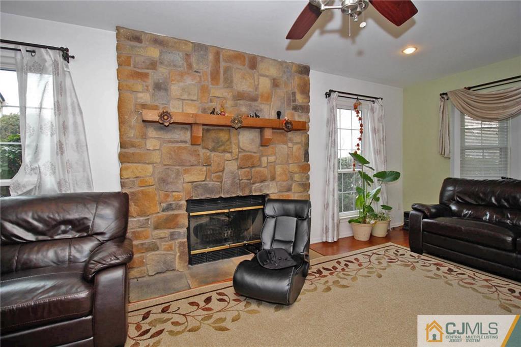 601 Maplecrest Road, Unit 601 Edison, NJ 08820 - Photo 15 of 25 a living room with furniture windows and a fireplace