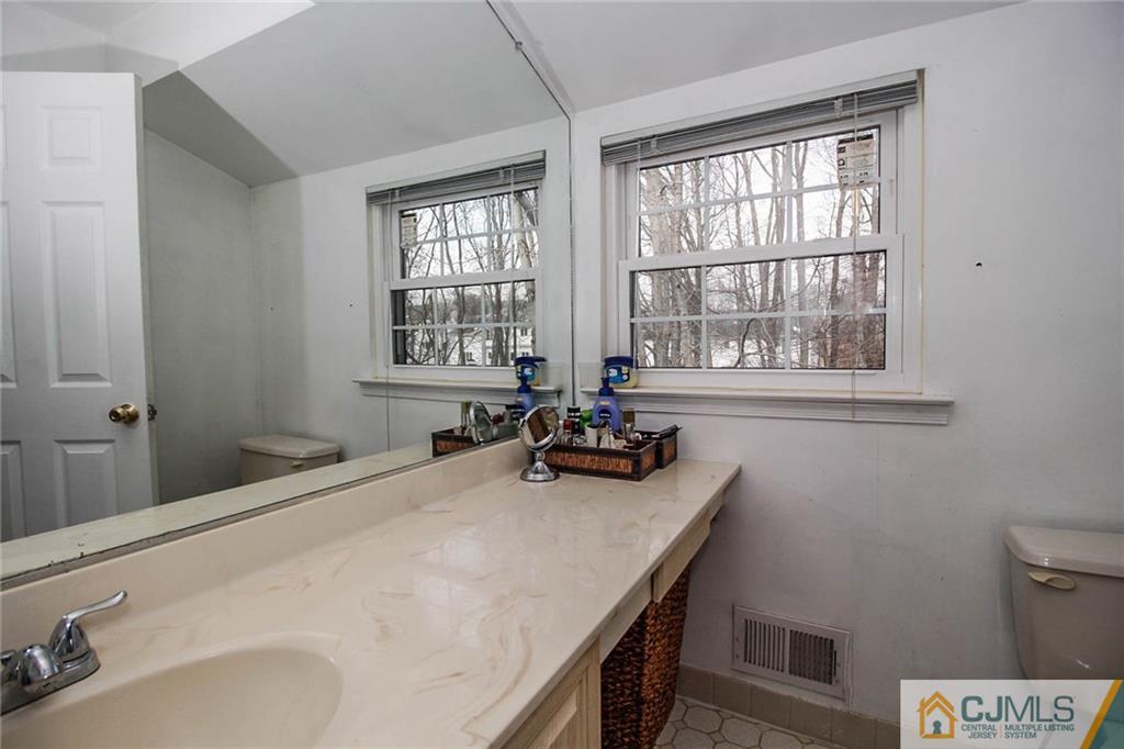 601 Maplecrest Road, Unit 601 Edison, NJ 08820 - Photo 16 of 25 a bed sitting in a bedroom next to a window
