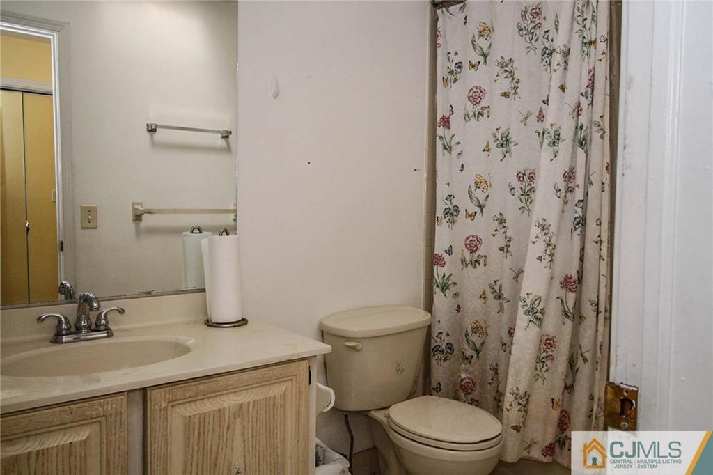 601 Maplecrest Road, Unit 601 Edison, NJ 08820 - Photo 17 of 25 a bathroom with a granite countertop toilet sink and a mirror