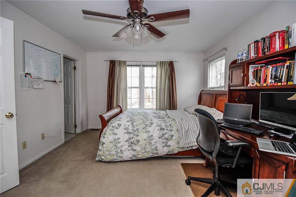 601 Maplecrest Road, Unit 601 Edison, NJ 08820 - Photo 18 of 25 a bedroom with furniture and a book shelf