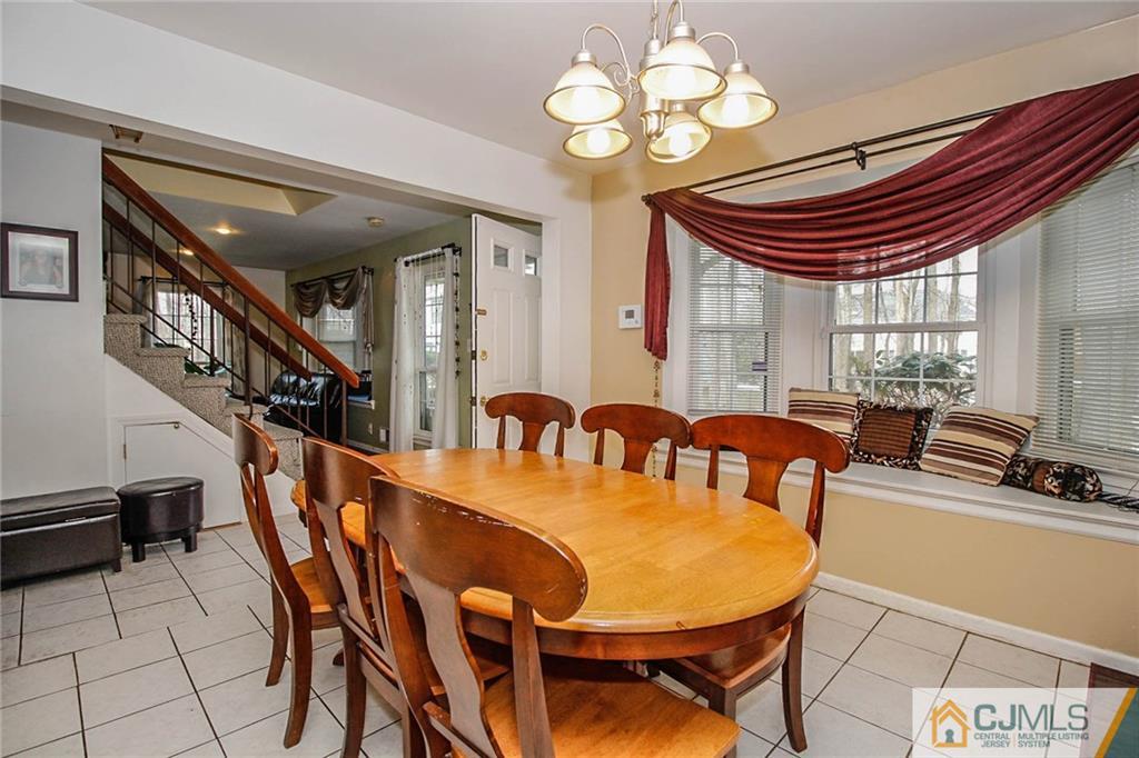 601 Maplecrest Road, Unit 601 Edison, NJ 08820 - Photo 6 of 25 a view of a dining room with furniture and a chandelier