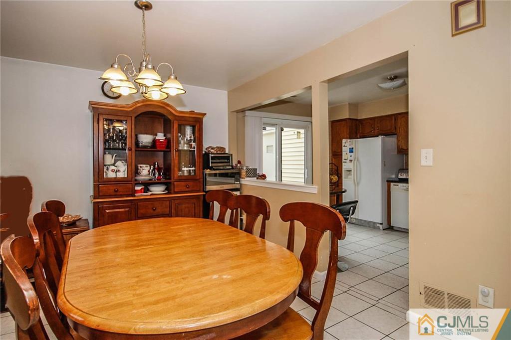 601 Maplecrest Road, Unit 601 Edison, NJ 08820 - Photo 7 of 25 a view of a dining room with furniture and a chandelier