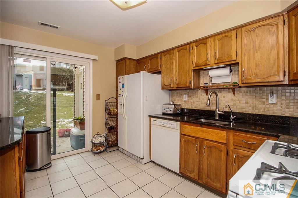 601 Maplecrest Road, Unit 601 Edison, NJ 08820 - Photo 9 of 25 a kitchen with stainless steel appliances granite countertop a refrigerator a stove and a sink
