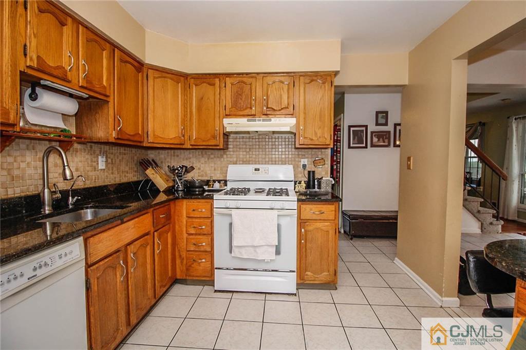 601 Maplecrest Road, Unit 601 Edison, NJ 08820 - Photo 10 of 25 a kitchen with stainless steel appliances granite countertop a stove a sink and a refrigerator