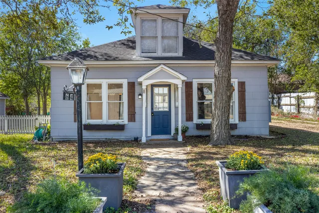 a front view of a house with garden