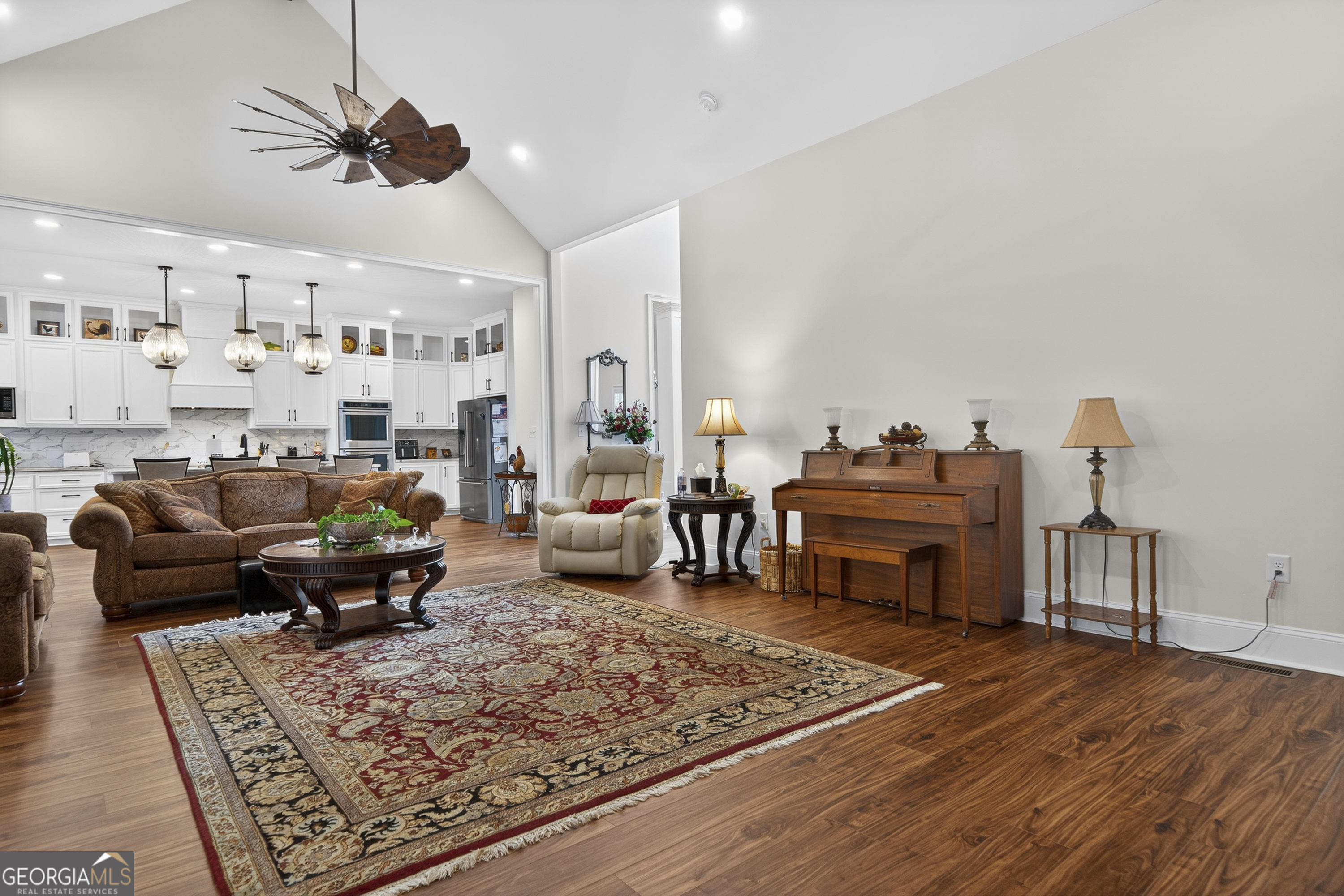 137 Butler Road Southeast Milledgeville, GA 31061 - Photo 16 of 82 a living room with furniture a rug and a chandelier