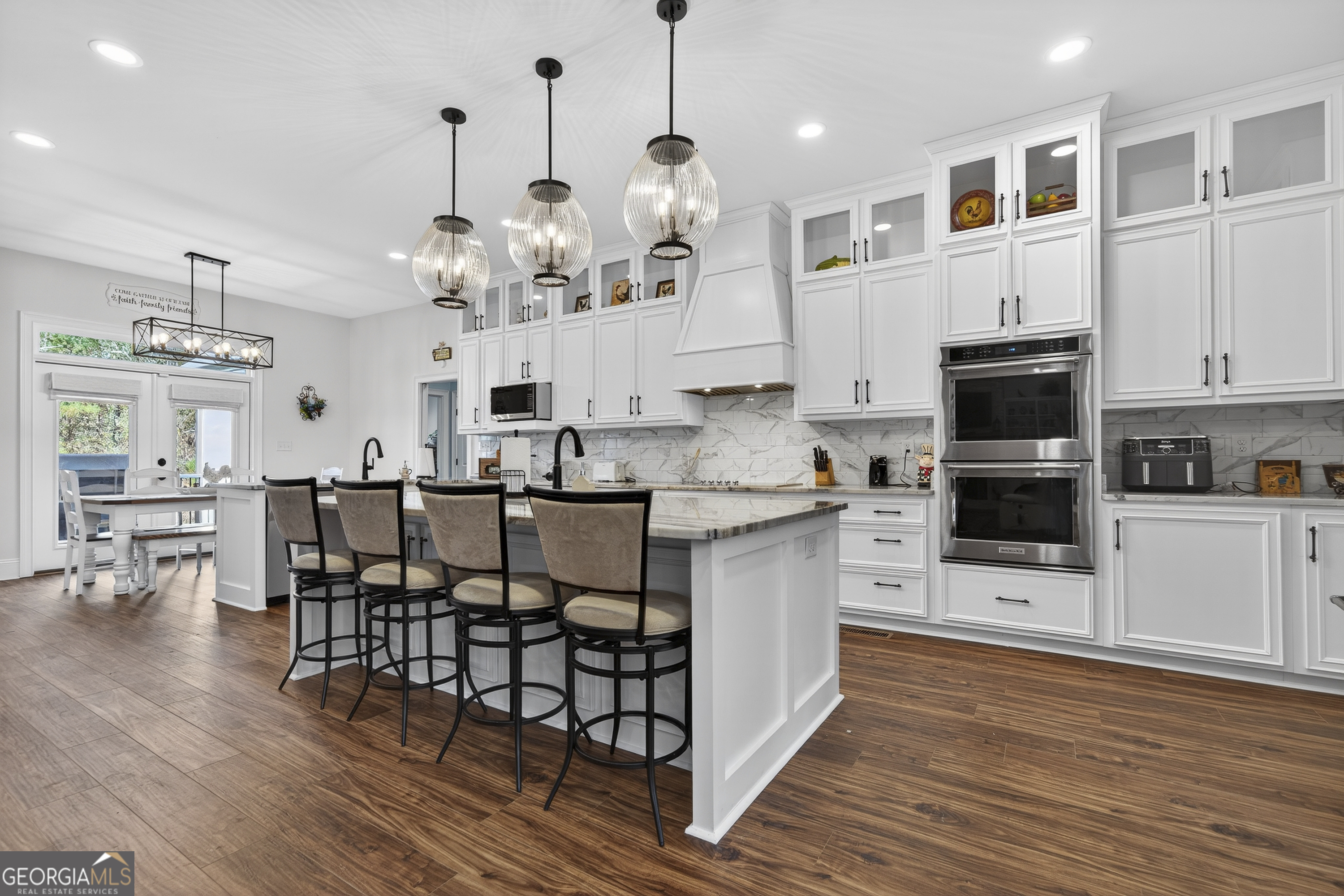 137 Butler Road Southeast Milledgeville, GA 31061 - Photo 17 of 82 a kitchen with stainless steel appliances granite countertop a refrigerator a stove top oven a sink dishwasher and a dining table with wooden floor