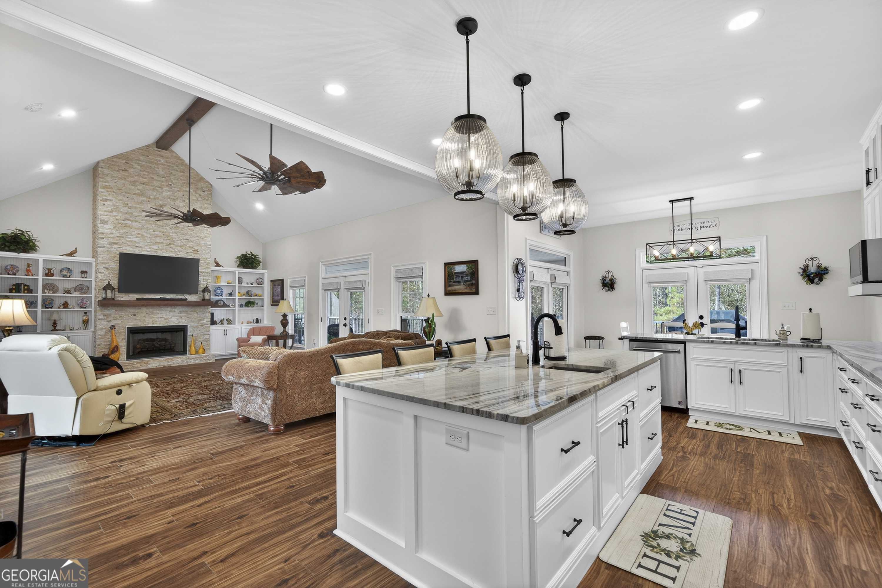 137 Butler Road Southeast Milledgeville, GA 31061 - Photo 22 of 82 a kitchen with stainless steel appliances granite countertop a sink dishwasher a dining table and chairs with wooden floor