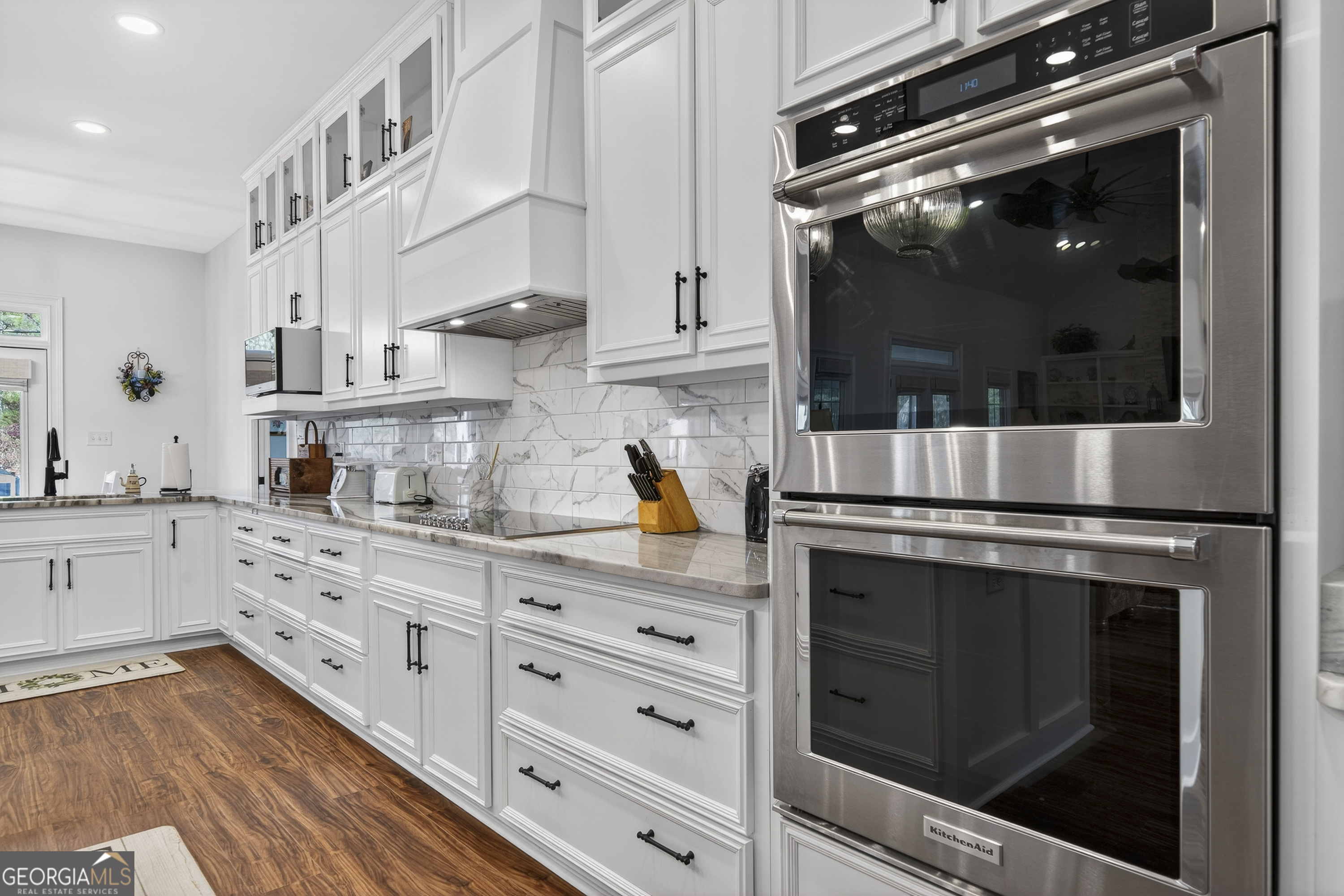 137 Butler Road Southeast Milledgeville, GA 31061 - Photo 23 of 82 a kitchen with stainless steel appliances white cabinets and a stove