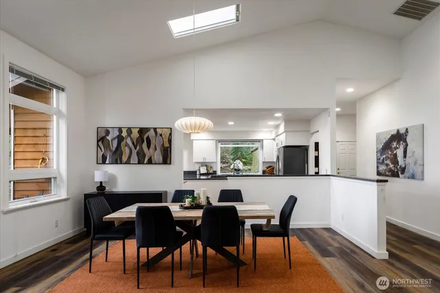a large kitchen with a table and chairs