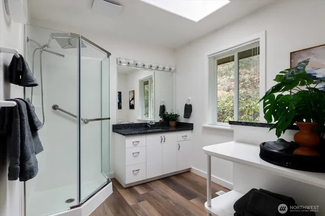 a kitchen with granite countertop a sink stainless steel appliances and cabinets