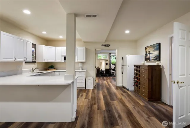 a kitchen with counter top space a sink cabinets and appliances