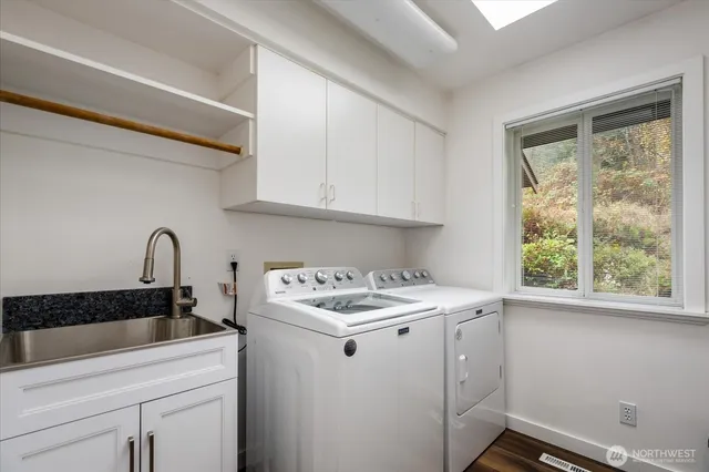 a utility room with sink dryer and washer