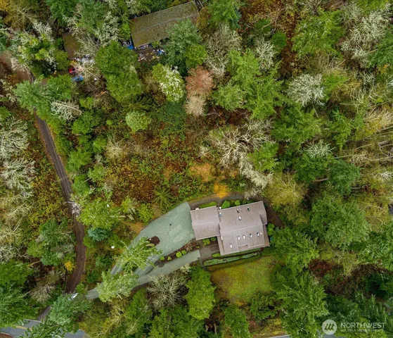 an aerial view of a house with a yard