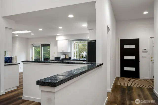 a kitchen with stainless steel appliances granite countertop a stove and a refrigerator