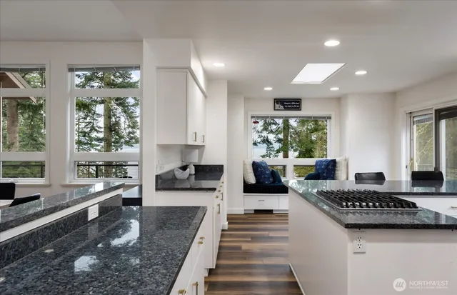 a large white kitchen with a large window