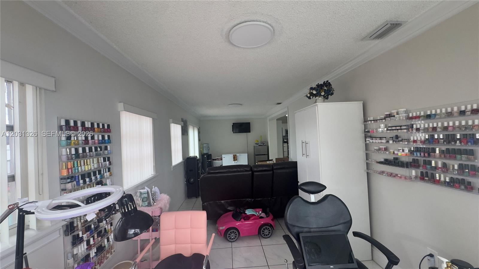 12480 Southwest 189th Street Miami, FL 33177 - Photo 17 of 25 a living room with furniture cabinets and a window