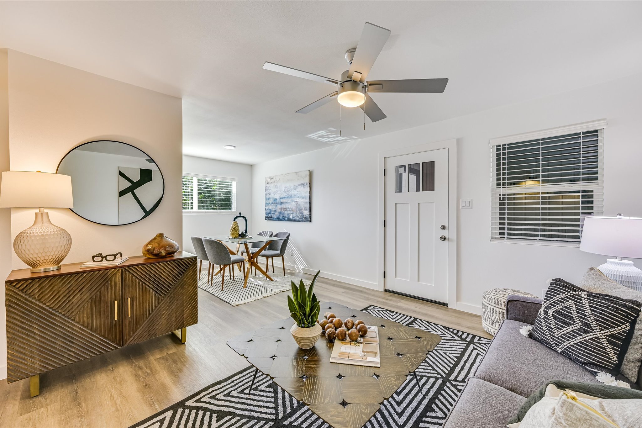 a living room with furniture a rug and a window