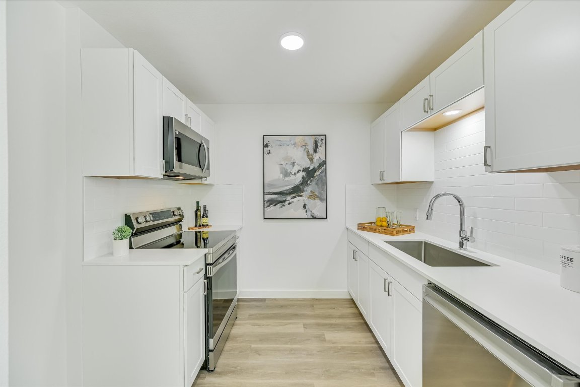 3703 Harmon Avenue, Unit 206 Austin, TX 78705 - Photo 1 of 10 a kitchen with stainless steel appliances granite countertop a sink and a stove top oven