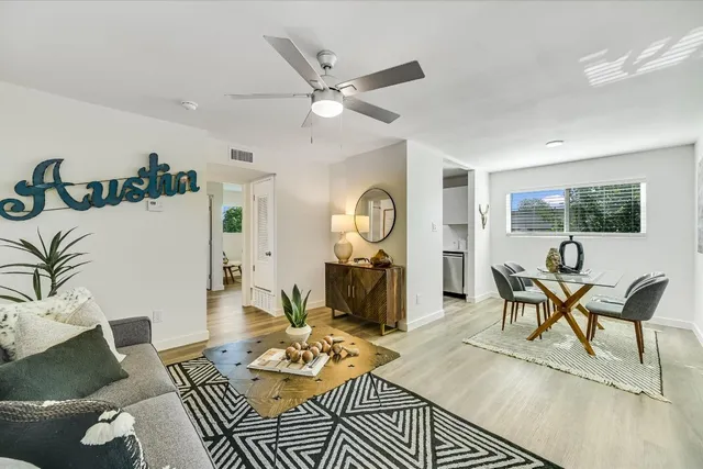 a living room with furniture and wooden floor