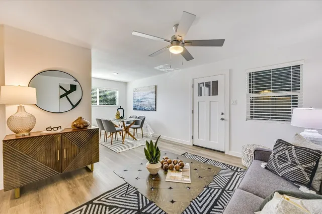 a living room with furniture a rug and a window