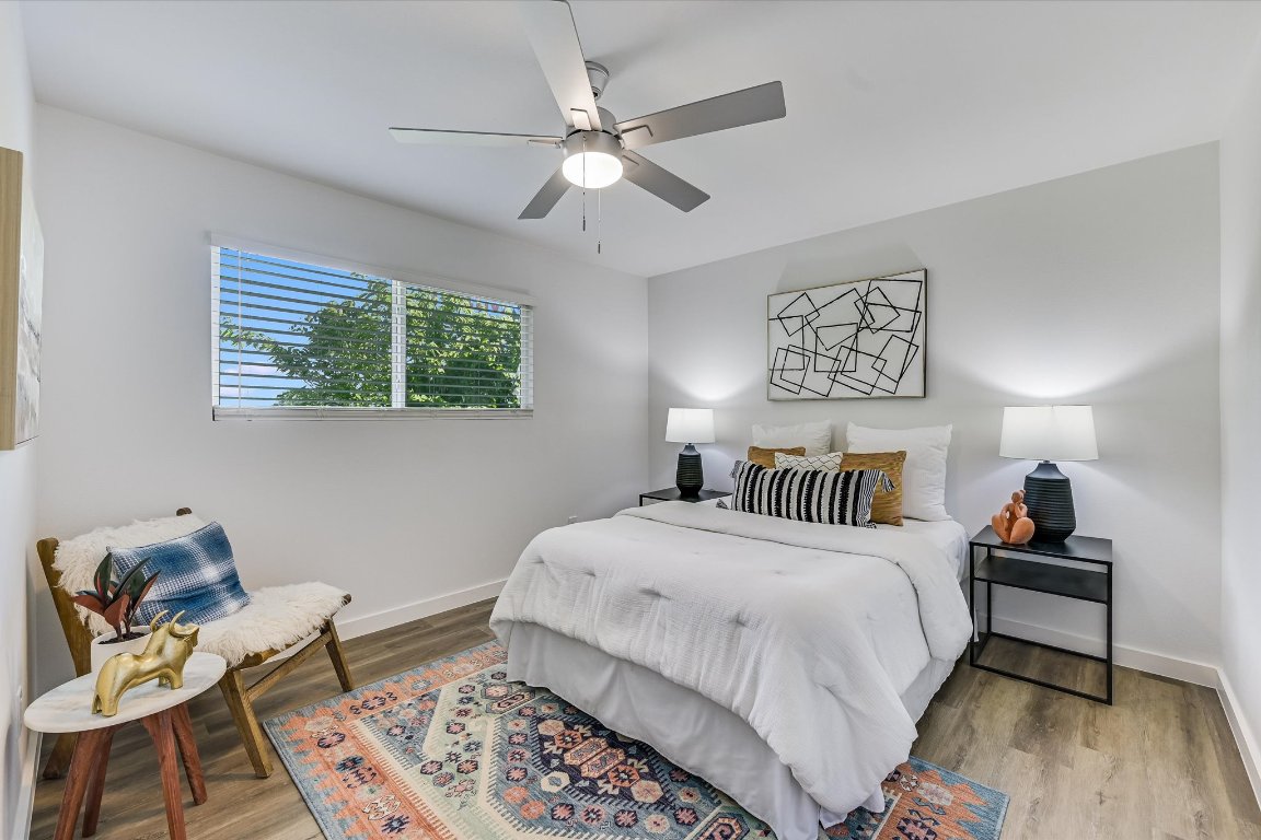 3703 Harmon Avenue, Unit 206 Austin, TX 78705 - Photo 7 of 10 a bedroom with a bed and a chandelier