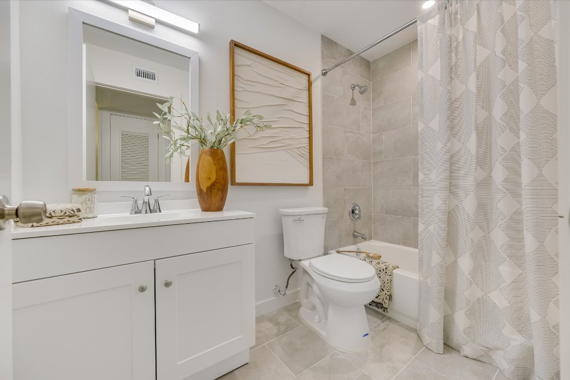 3703 Harmon Avenue, Unit 206 Austin, TX 78705 - Photo 8 of 10 a bathroom with a toilet sink and mirror
