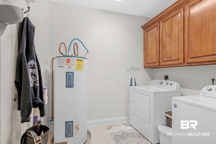24541 Baldwin Beach Expressway Robertsdale, AL 36567 - Photo 23 of 51 Clothes washing area with light tile patterned flooring, washing machine and dryer, baseboards, electric water heater, and cabinet space