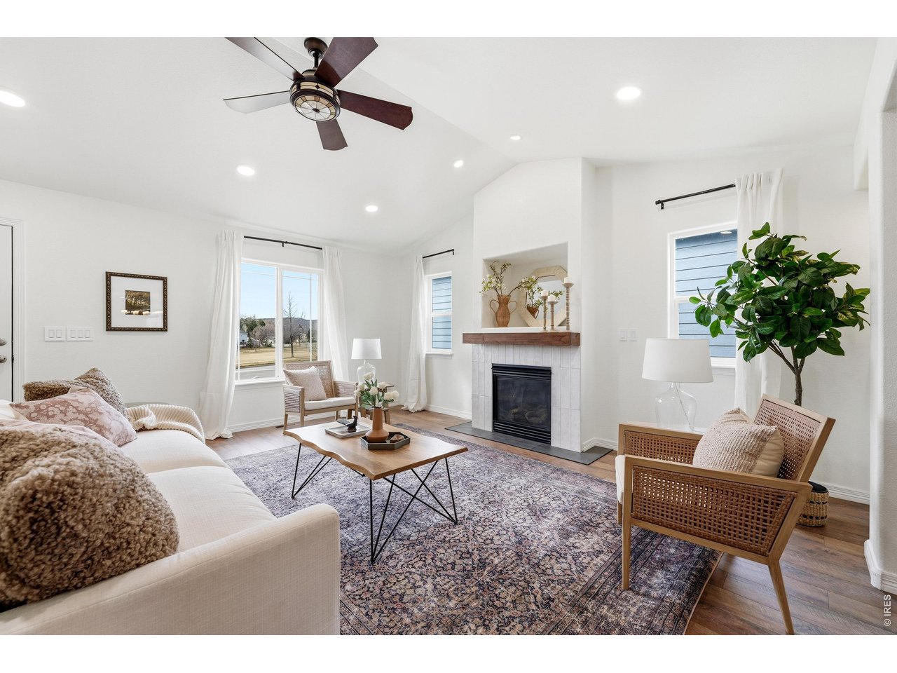 2802 Pleasant Valley Road Fort Collins, CO 80521 - Photo 3 of 17 a living room with furniture a chandelier and a fireplace