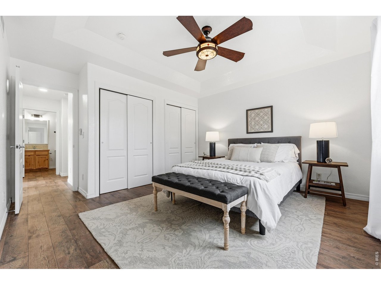 2802 Pleasant Valley Road Fort Collins, CO 80521 - Photo 8 of 17 a bedroom with a bed and a chandelier