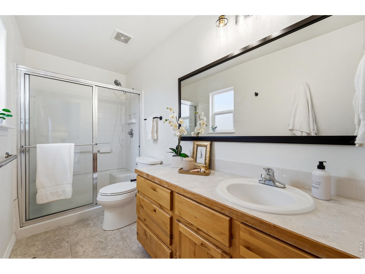 2802 Pleasant Valley Road Fort Collins, CO 80521 - Photo 9 of 17 a bathroom with a granite countertop sink toilet a mirror and shower